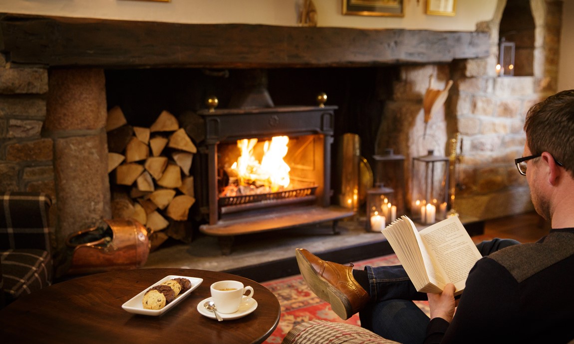 Reading by the fire in the cosy lounge