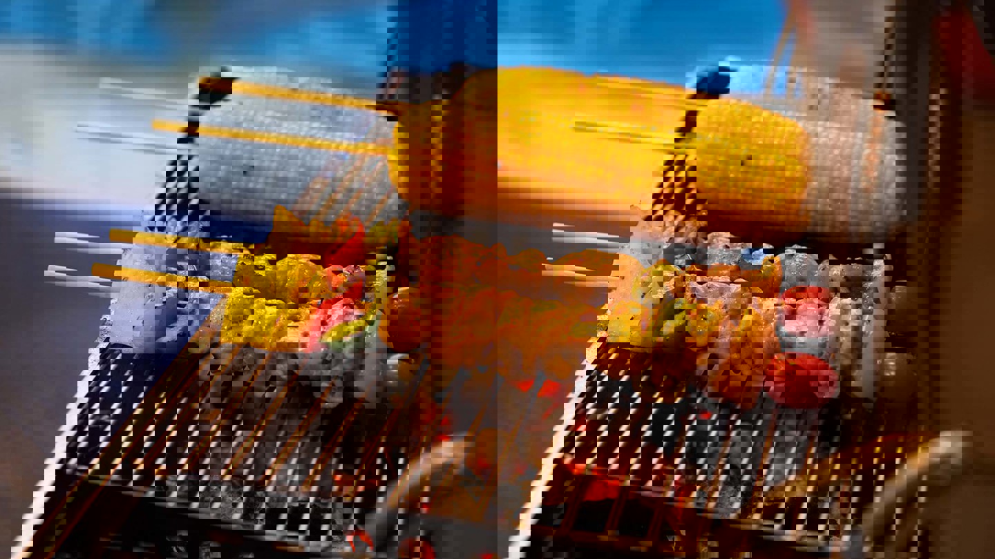 Kebabs and corn on a bbq