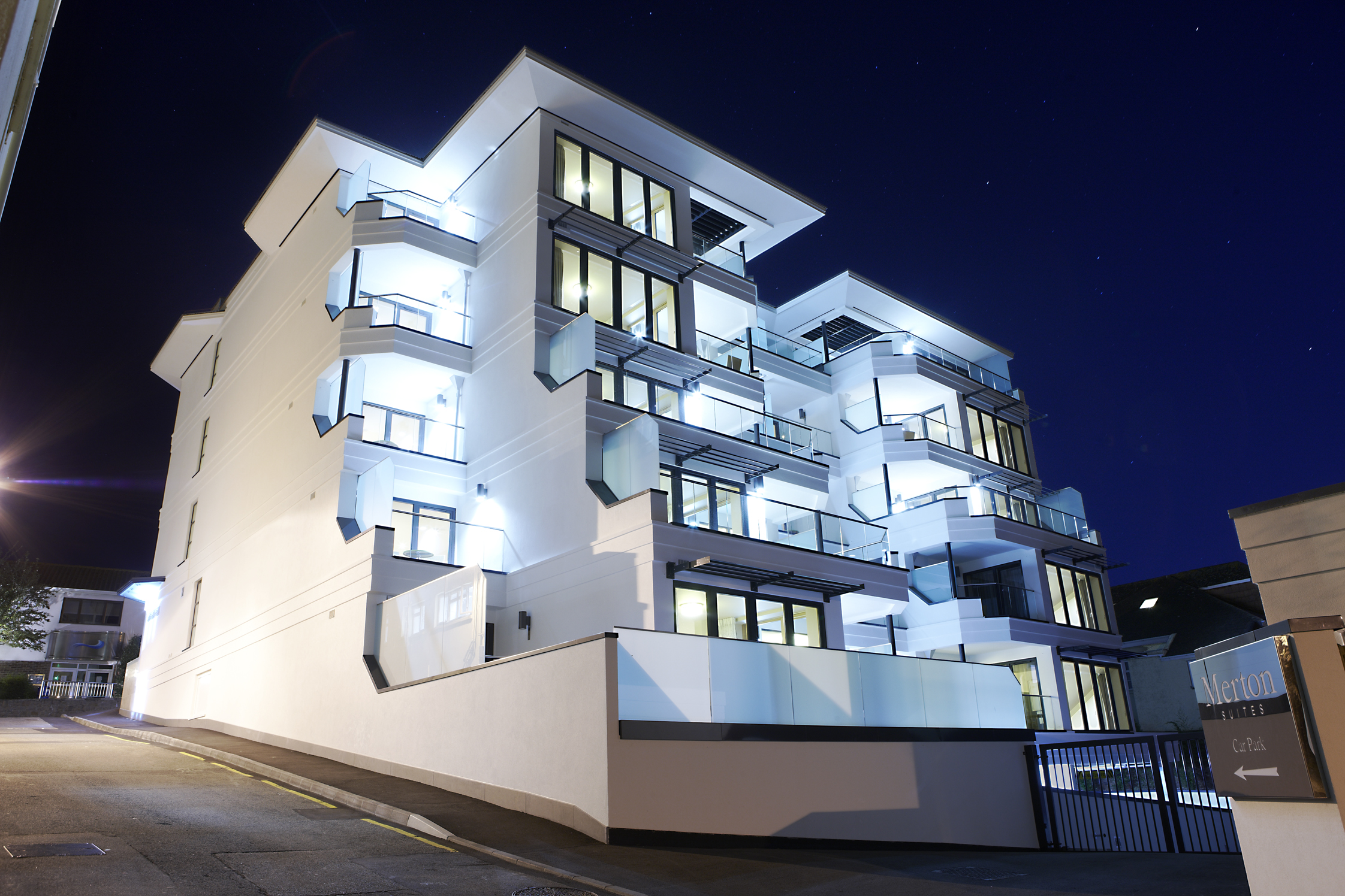 External view of the Merton Suites building, lit up at night