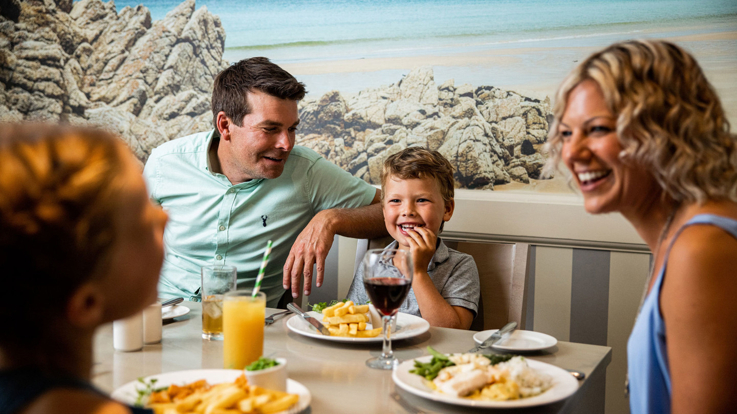 Happy family has dinner at The Belvedere restaurant