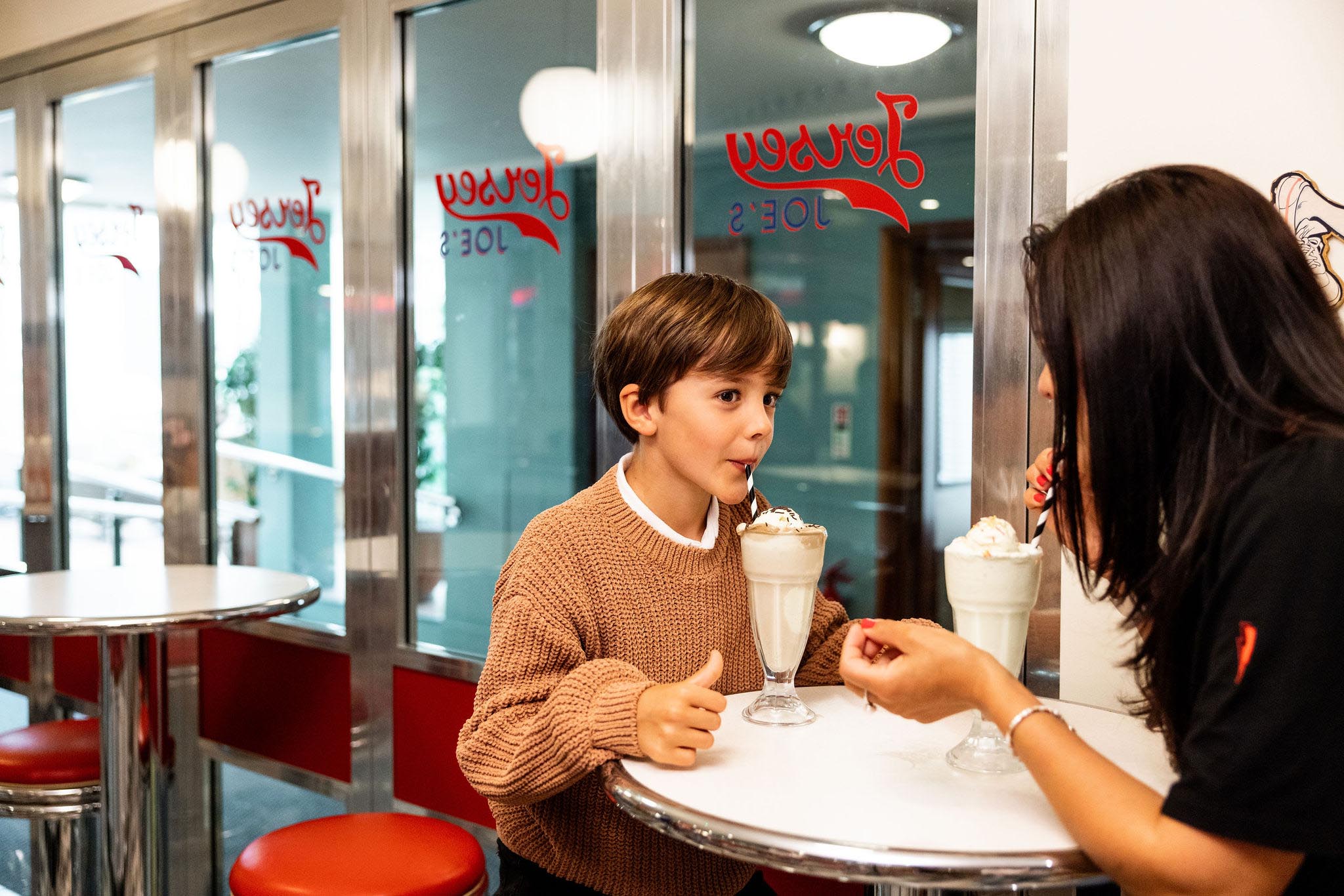 Mother and son enjoying milkshakes at Jersey Joes