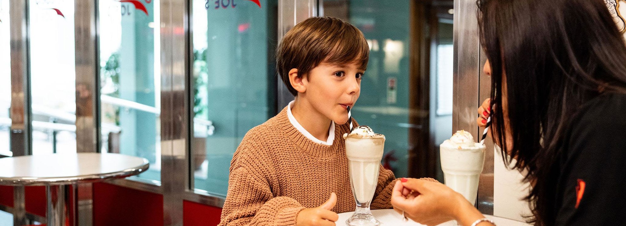 Mother and son enjoying milkshakes at Jersey Joes