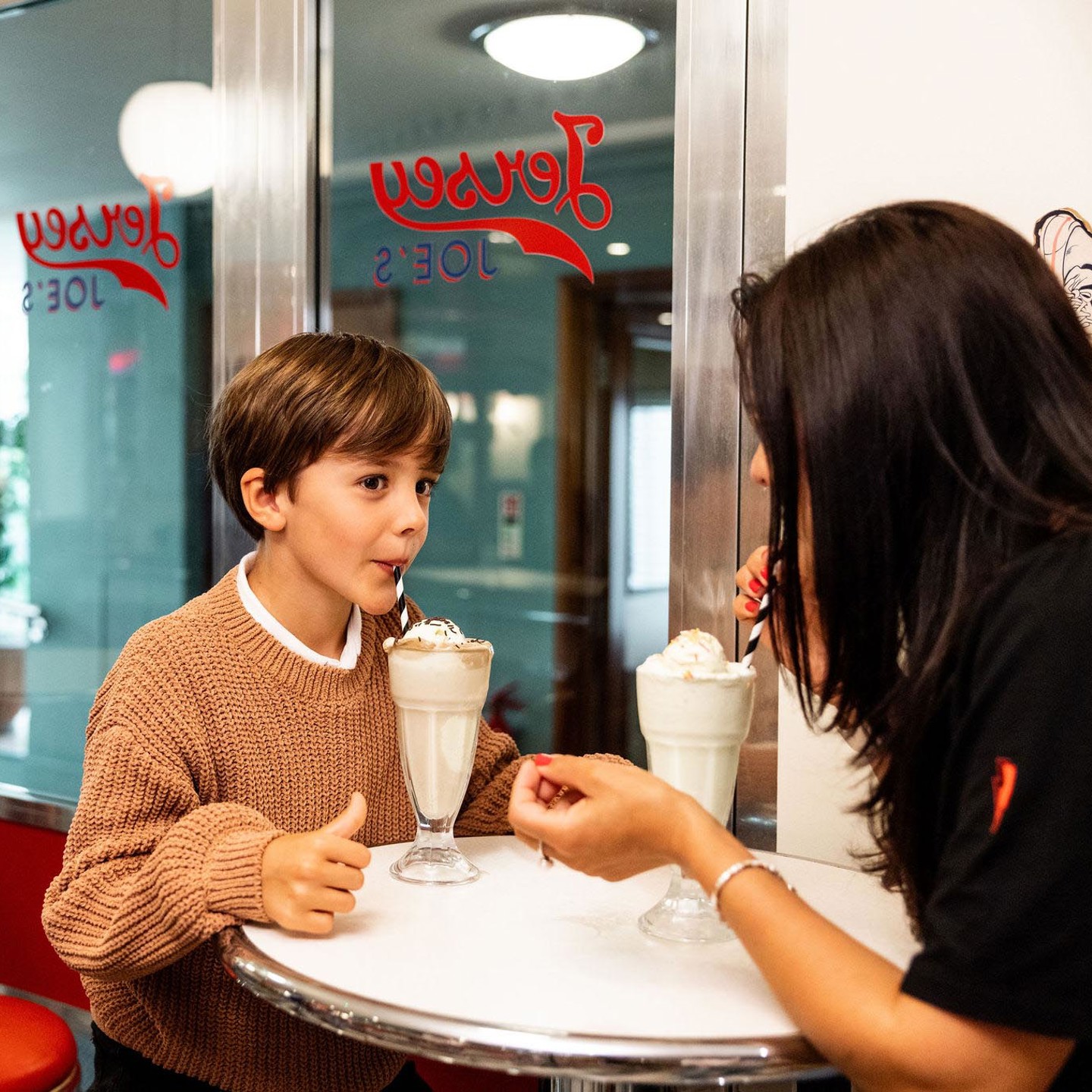 Mother and son enjoying milkshakes at Jersey Joes